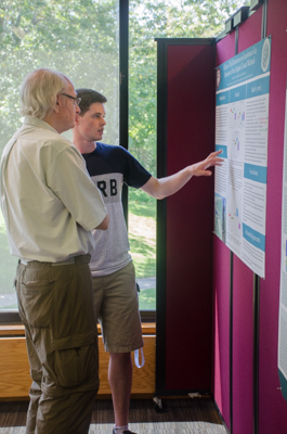 Leron Perez of University of Chicago explains his poster to MBL Distinguished Scientist Ivan Valiela. Perez studied greenhouse gas emissions in coastal wetlands with MBL Associate Scientist Jim Tang.