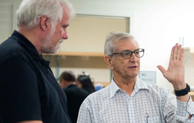 Francisco Bezanilla explains a concept to MBL scientist Steve Senft during an open house