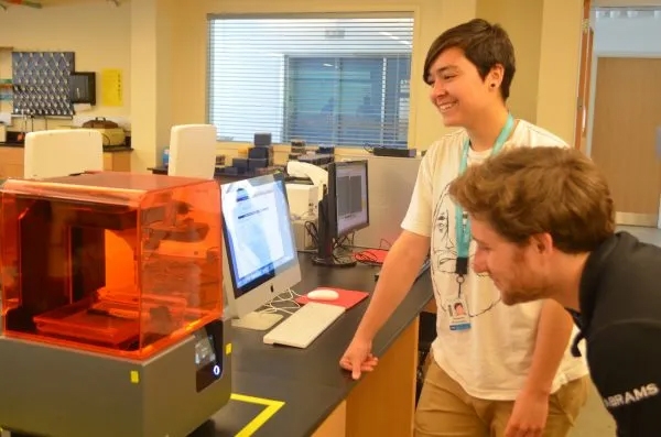 Embryology course students Kate Woronowicz and Mike Abrams test the 3D printer loaned to the course.