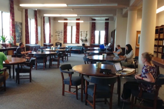 People sitting at tables in the library.