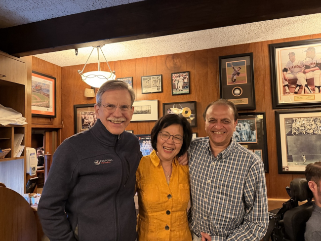 Three people smiling at the camera