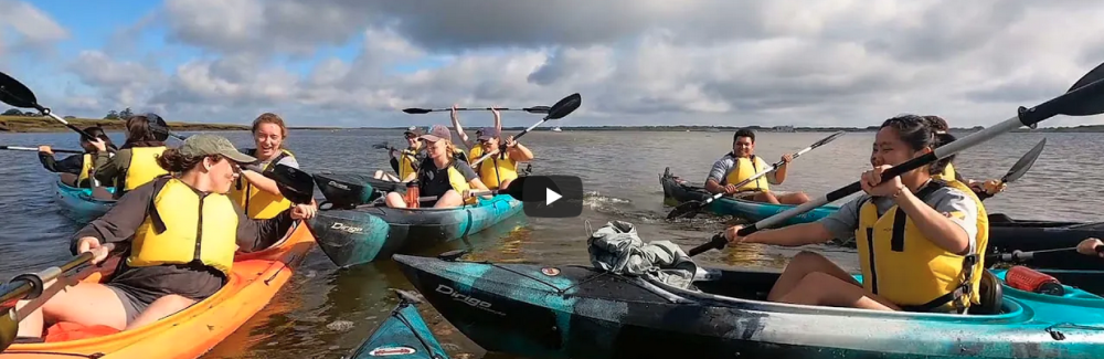 students laughing in kayaks