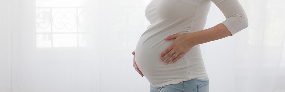 pregnant woman holding stomach