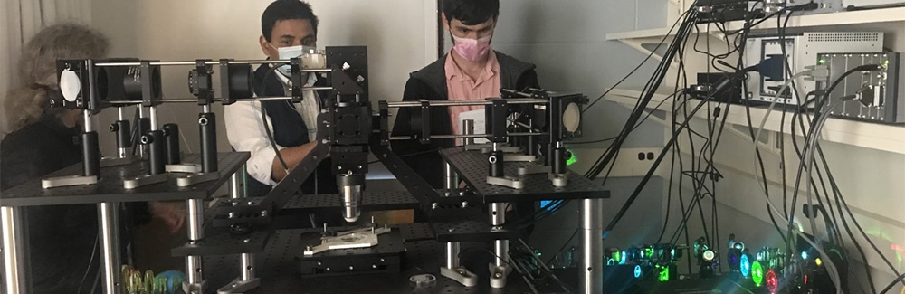 Abhishek Kumar (center) with microscope