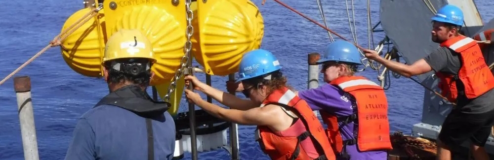 Marine Biological Laboratory Fellow Maureen Conte (center right) and crew of the R/V Atlantic Explorer recover a deep ocean sediment trap. (Courtesy J.C. Weber)