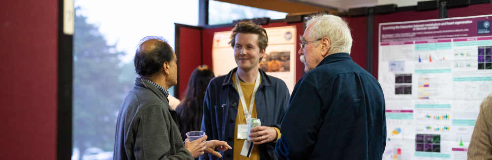 Header photo: MBL Director Nipam Patel (left) and Nobel Prize winner and Embryology alumnus Eric Weichaus (right) talk with a student during the poster session.