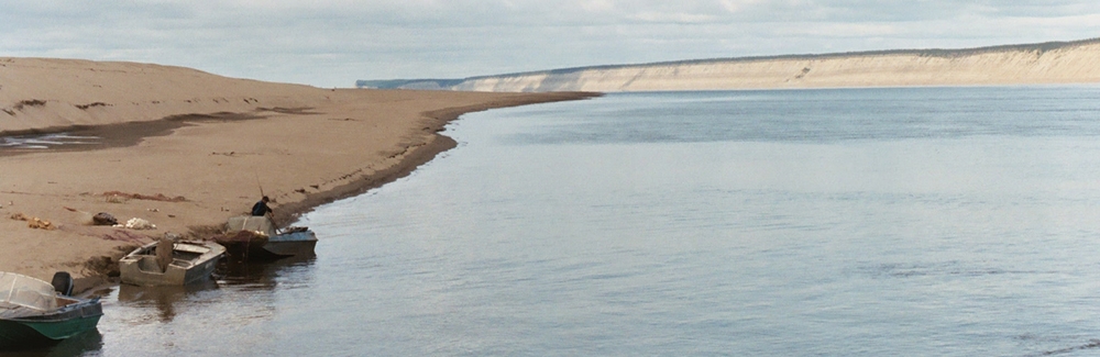 The Lena River in Siberia with boats used by fisherman.