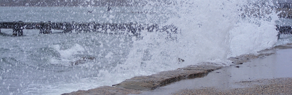 Waves crashing up onto MBL's Waterfront Park.