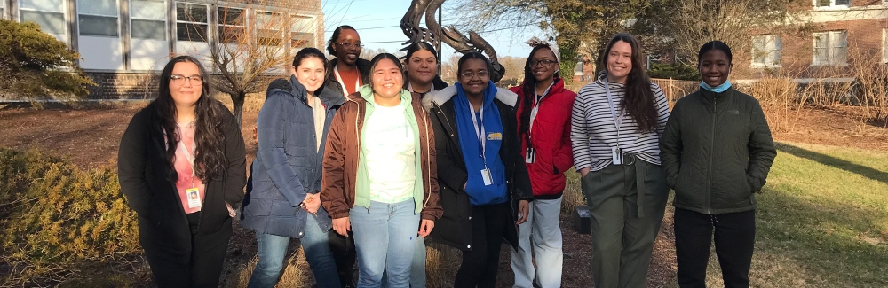 Eight students from the New Bedford Whaling Museum Apprenticeship Program pose on the MBL Quad.