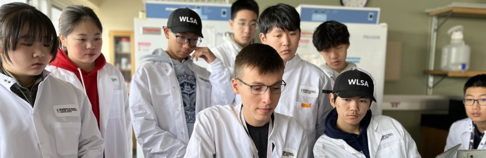 Students from WLSA Shanghai Academy watch DNA being sequenced in real time by ENGAGE-Bio postbaccalaureate scholar Jaden Hansen. Credit: Alex Megerle