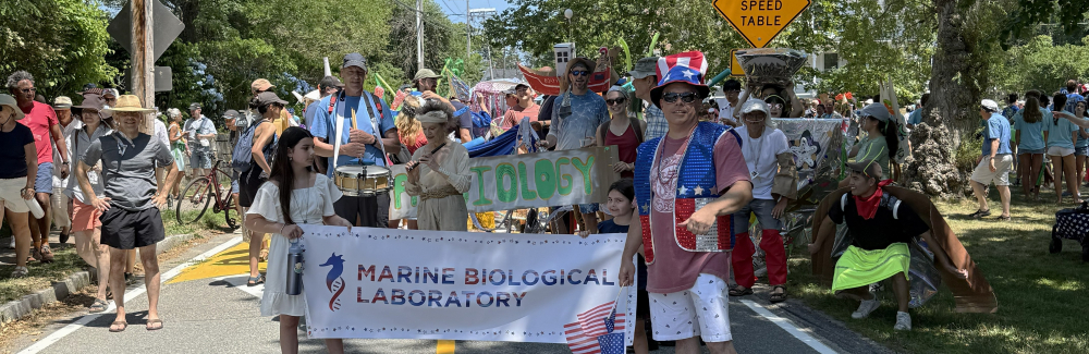 July 4th Parade. MBL banner and people in background ready to march. 