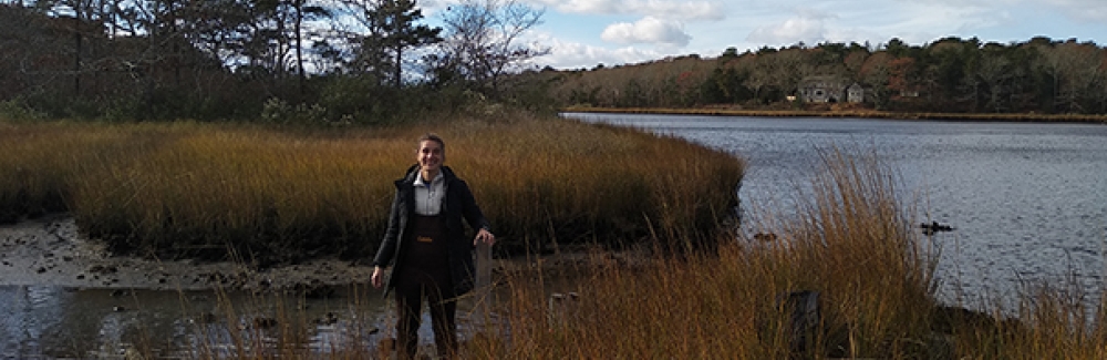 Semester in Environmental Science (SES) Student Claire McGuire prepares to take a sediment core sample in Waquoit Bay, Mass