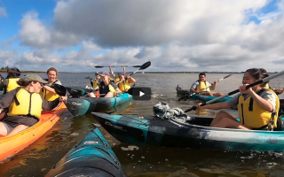 students laughing in kayaks