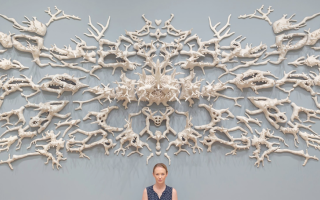 Courtney Mattison with her “Malum Geminos” (2019), which she adapted for “Turn the Tide.” The title was inspired by biologist Jane Lubchenco’s reference to the “evil twins” of climate change and ocean acidification in causing coral reefs to sicken, bleach and erode. Credit: Courtney Mattison/Florence Griswold Museum