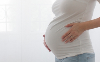 pregnant woman holding stomach