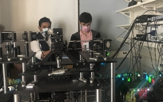 Abhishek Kumar (center) with microscope