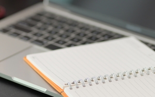 Laptop and notebook on a desk