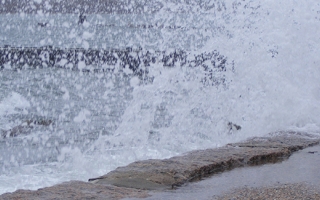 Waves crashing up onto MBL's Waterfront Park.