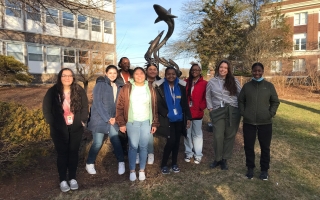 Eight students from the New Bedford Whaling Museum Apprenticeship Program pose on the MBL Quad. 