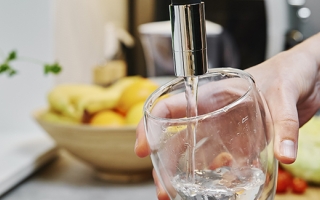 Woman pouring water into a glass from faucet.