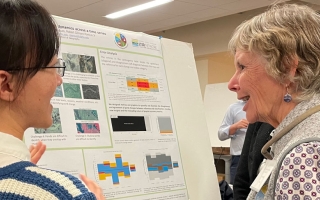 two people stand infront of a poster at the 2024 Plum Island Ecosystems LTER annual meeting at the MBL. Credit: Diana Kenney