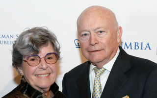 Valerie Rowe on the left and Jack Rowe on the right posing at a benefit. 