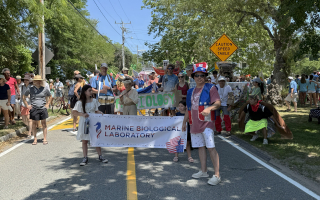 July 4th Parade. MBL banner and people in background ready to march. 