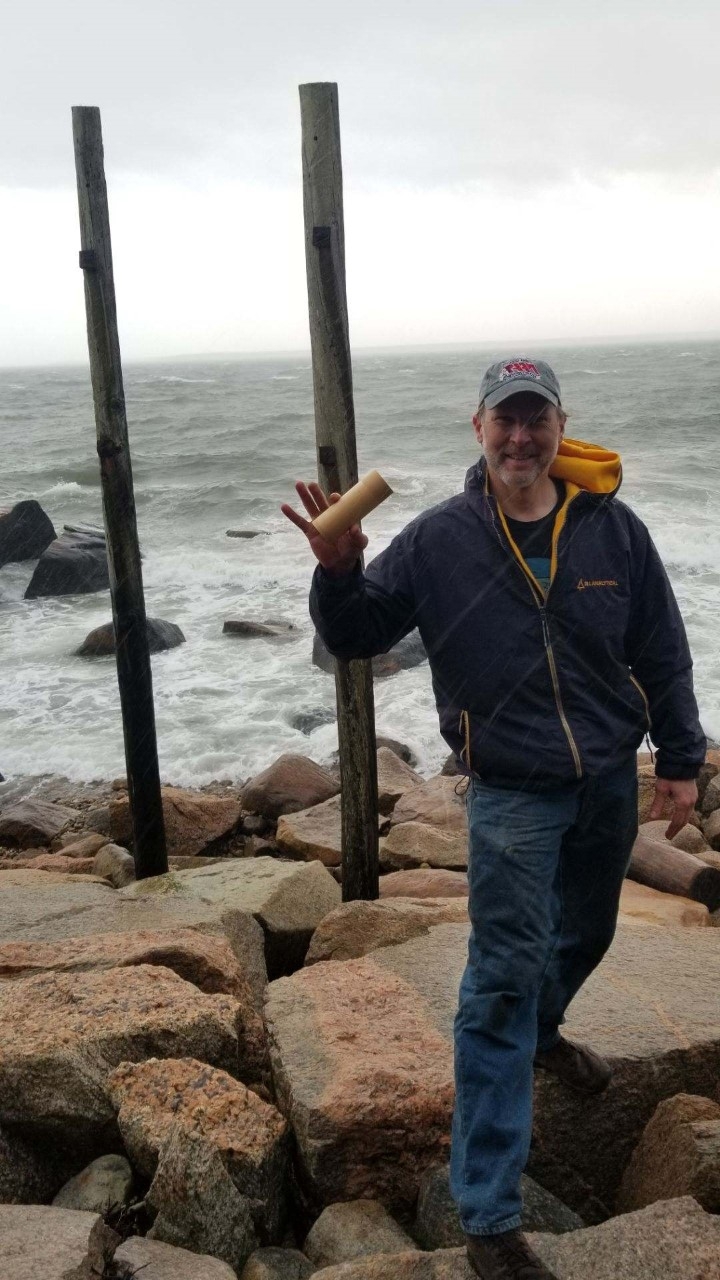 Eric Jensen holds message in bottle