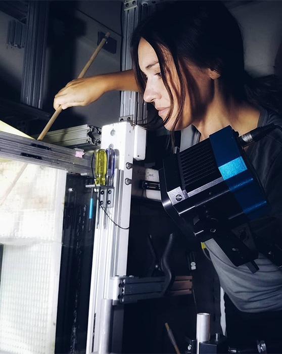 Valentina Di Santo examining a flow tank at Harvard University. Credit: Perry Leenhouts