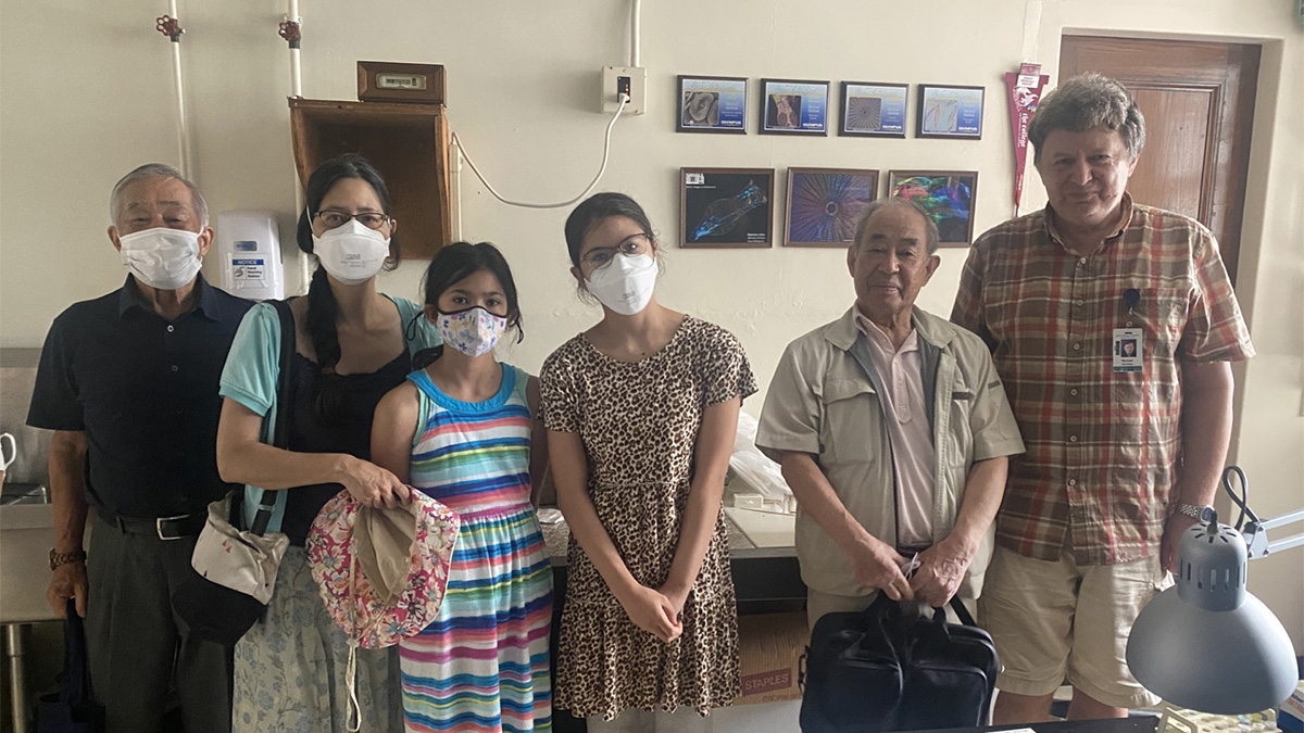 Visiting the former lab of Osamu and Akemi Shimomura in the Lillie Building are, from left, Takeshi Okubo, Mika and Emi, Akihiro Okubo, and Sachi Shimomura. At right is MBL Senior Scientist Michael Shribak.