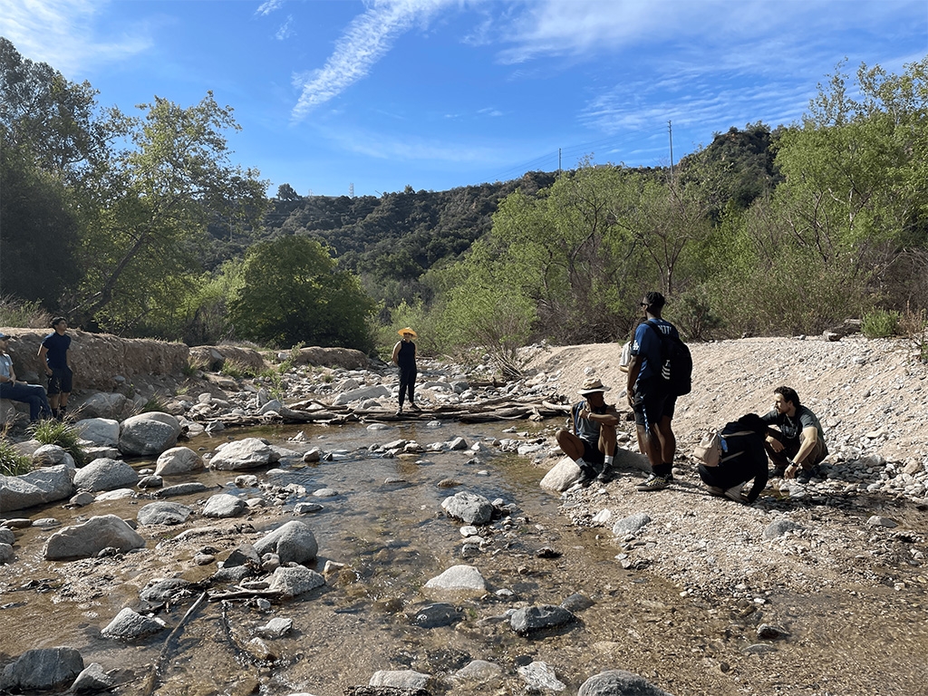 Students taking samples. The AP Biology teacher can be seen observing the activities in the center.