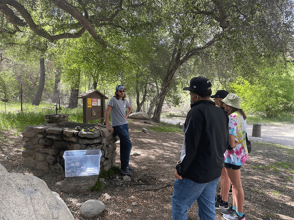 Figure 3: Caltech volunteer (left) teaches about Winogradsky columns and explains the exercise. We used a premade column as an example.