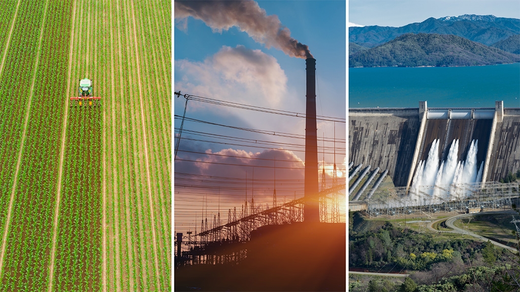 Field with tractor, a smokestack and a dam