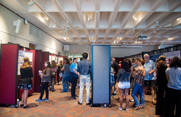 Members of the MBL community chat with undergraduate researchers at their poster session