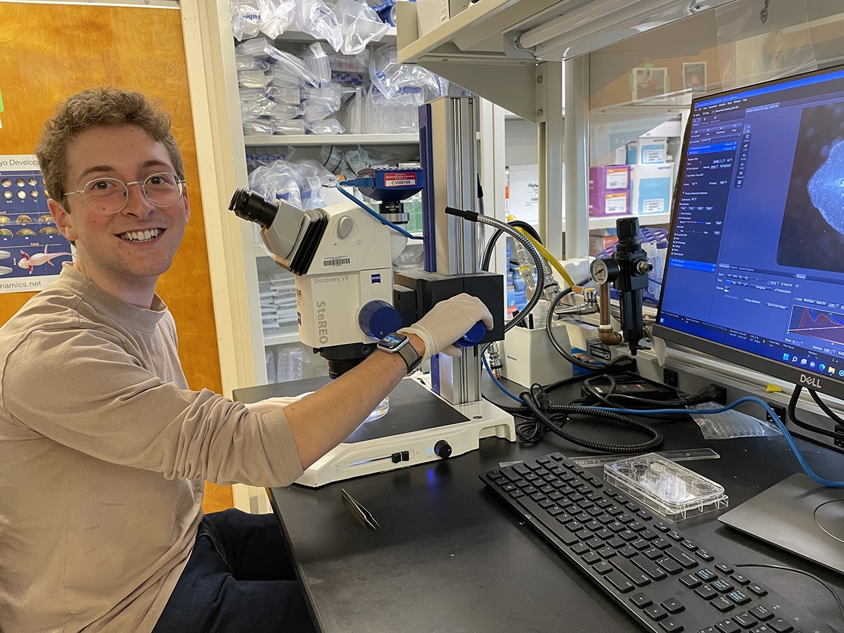 Christian Selden at a microscope in the Echeverri Lab. 