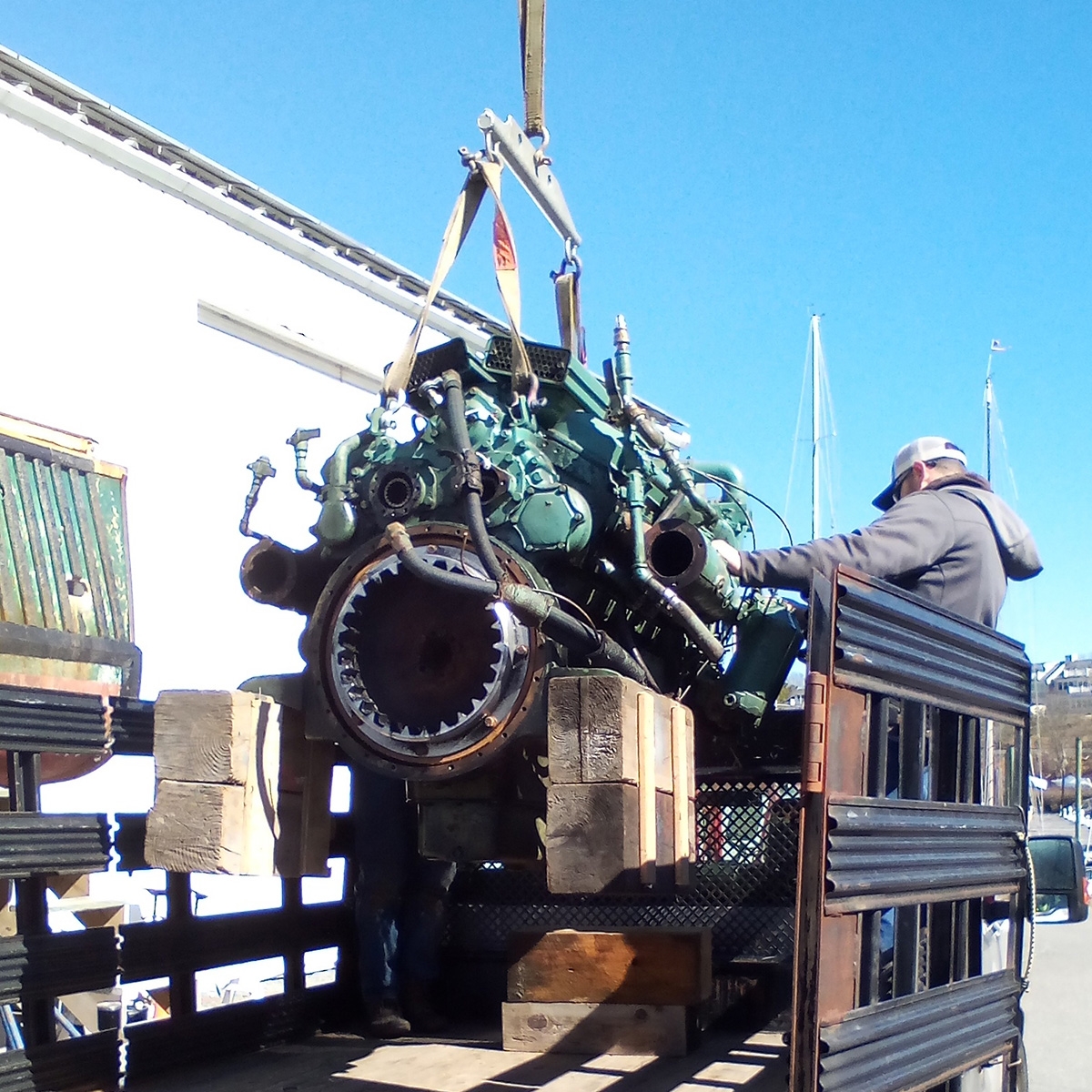 Previous Gemma engine being removed by crane at Kingman Yacht Center.