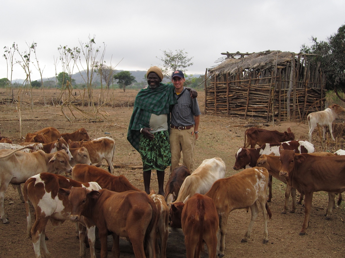 Mayes takes a break with Makenzie Pumla, a Sukuma herdsman, Tabora, Tanzania, April 2015.
