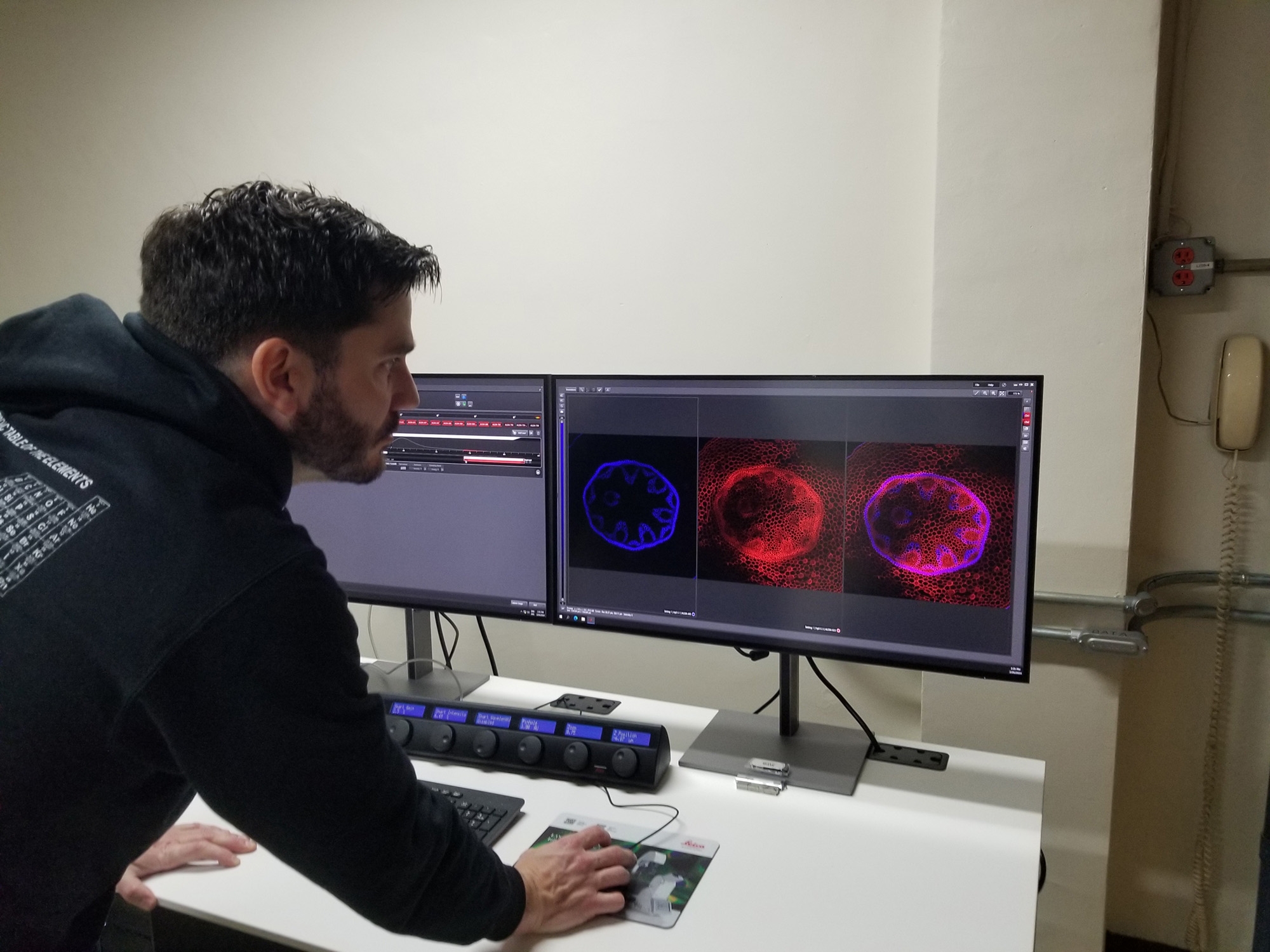 Man standing in front of two monitors.