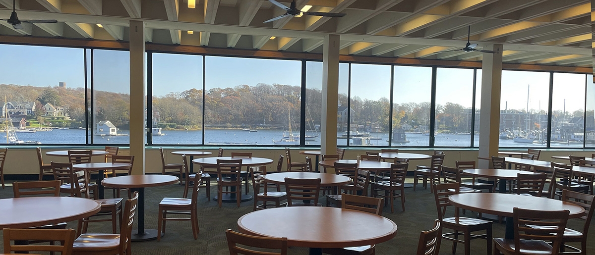 Swope Main Dining Hall showing empty tables overlooking Eel Pond