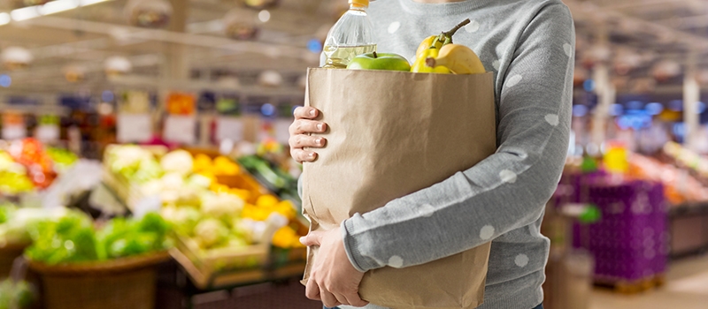Person holding groceries in the store.