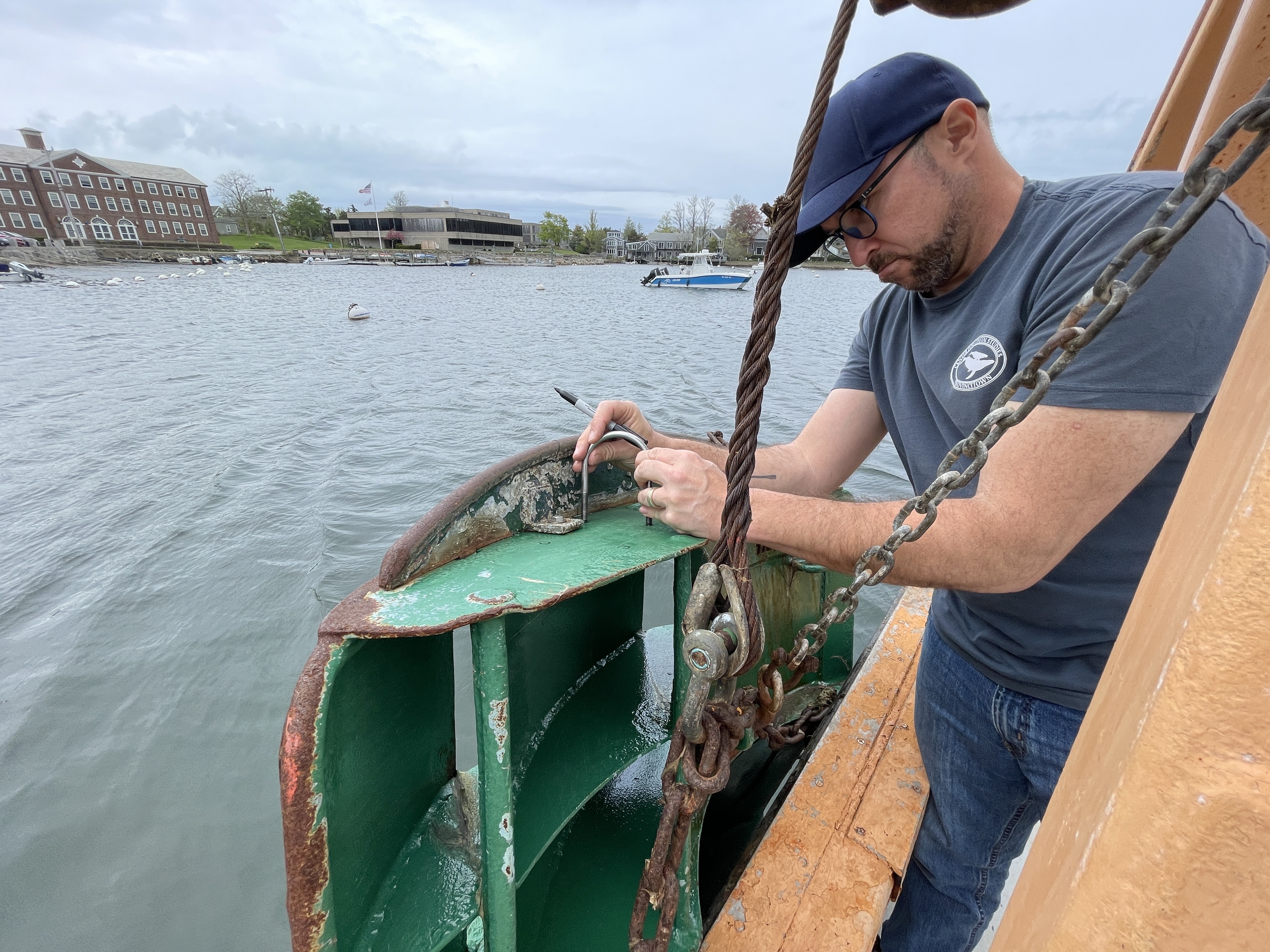 Owen Nichols installs the sensor on the trawl doors. Credit: George Maynard.
