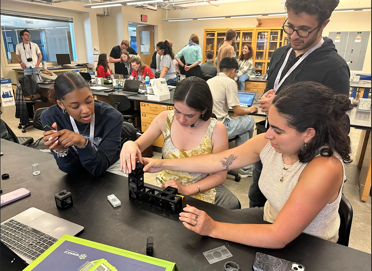 A team of scientists builds a microscope.