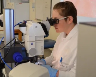 Heather Talbot at a microscope