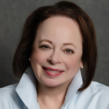 Female presenting person with shoulder length brown hair.