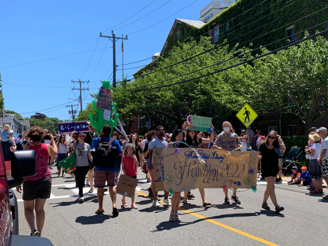 Students from the MBL Neurobiology course march in the 2022 Woods Hole Fourth of July Parade