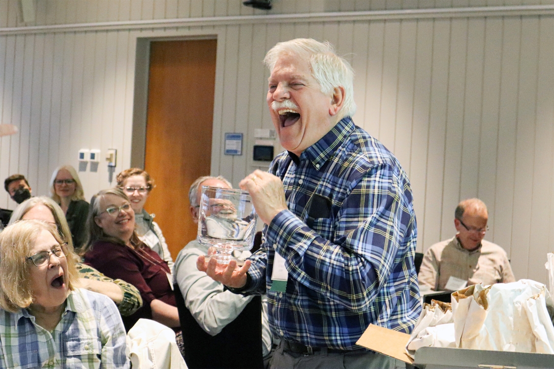 Former SES Director Ken Foreman recieves a gift in thanks of this long years as director. Credit: Emily Greenhalgh