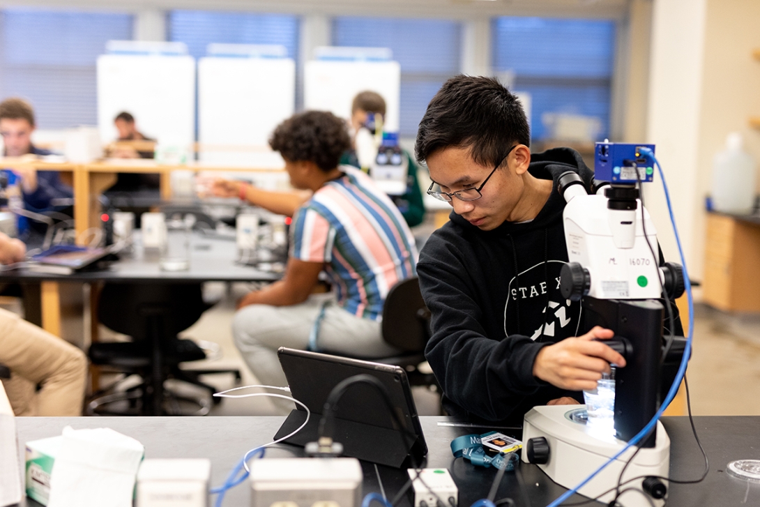 Students from the St. Anne's-Belfield School image corals on microscopes